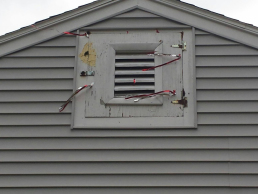 A customer is Burlington, MA called with a major woodpecker issue.  We hung Mylar Ribbon in the area where the woodpecker was pecking to deter the bird and get it to go some where else (Before)