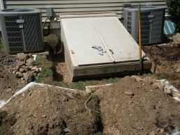 Groundhogs were burrowing under a bulk head in Lexington, MA-Critter Control dug a trench around the structure the animal was getting under