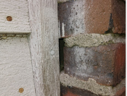 Mice were entering this home in Newton, MA through a gap in the brick siding (Before)