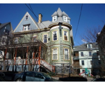Repairing squirrel entry hole at the roof line of a Jamaica Plain MA home