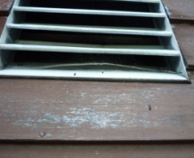 Bat entry point through a louvre vent in a home in Tewksbury Ma. The vent was screened and a one-way check valve was installed to evict the bats.