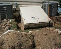 Groundhogs were burrowing under a bulk head in Lexington, MA-Critter Control dug a trench around the structure the animal was getting under