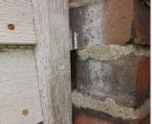 Mice were entering this home in Newton, MA through a gap in the brick siding (Before)