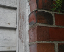 We sealed the gap in the brick siding where the mice were entering, blocking their entrance (After)