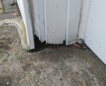 Mice were gaining access into a garage in Wilmington, MA.  We sealed off the rotted entrance with some Metal and Mortar. (Before)