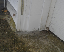Mice were gaining access into a garage in Wilmington, MA.  We sealed off the rotted entrance with some Metal and Mortar. (After)