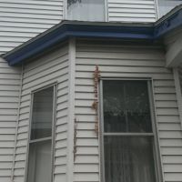 A customer wanted us to replace the blue trim on her home with metal flashing to prevent any animals from chewing the wood and making a home.The blue trim on this house was deteriorating in spots and vulnerable to squirrels chewing in (Before)